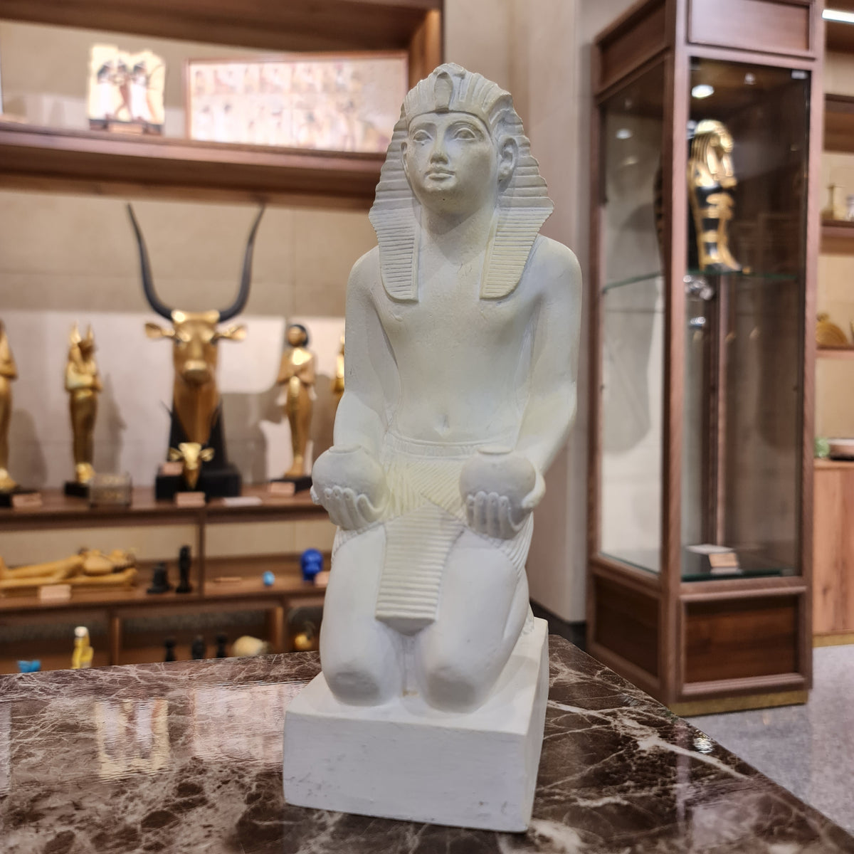 Kneeling Thutmose III statue museum reproduction shown at an angle