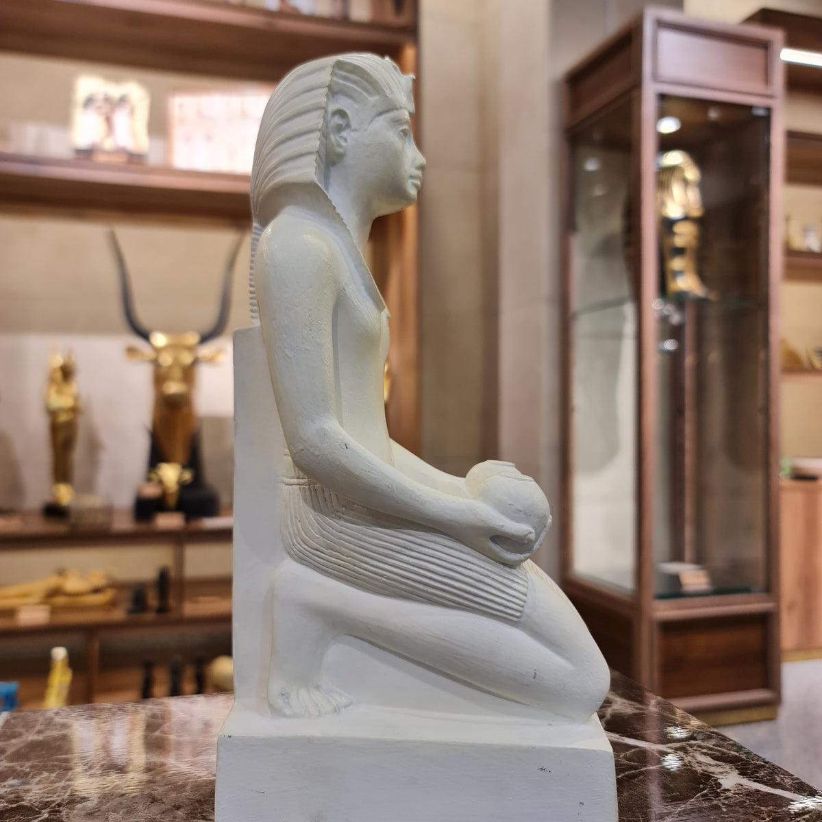 Full view of the kneeling Thutmose III statue museum reproduction