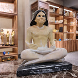 Seated scribe statue museum reproduction, three-quarter angled view