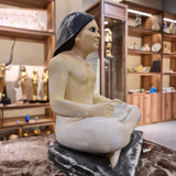 Seated scribe statue museum reproduction, side profile