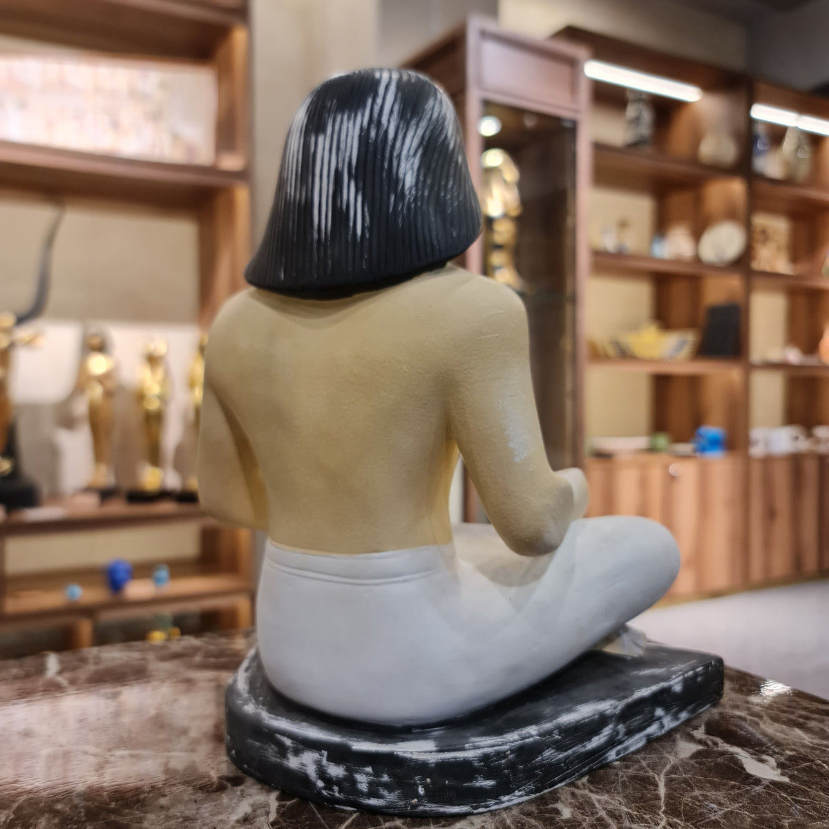 Seated scribe statue museum reproduction, back view