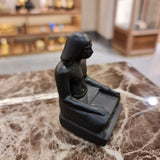 Black seated scribe statue museum reproduction, side profile
