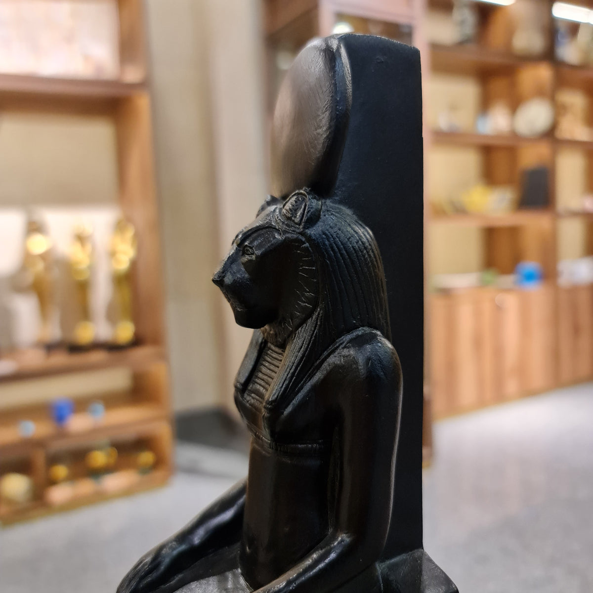 Sekhmet statue museum reproduction, close-up of the lioness head and solar disk crown