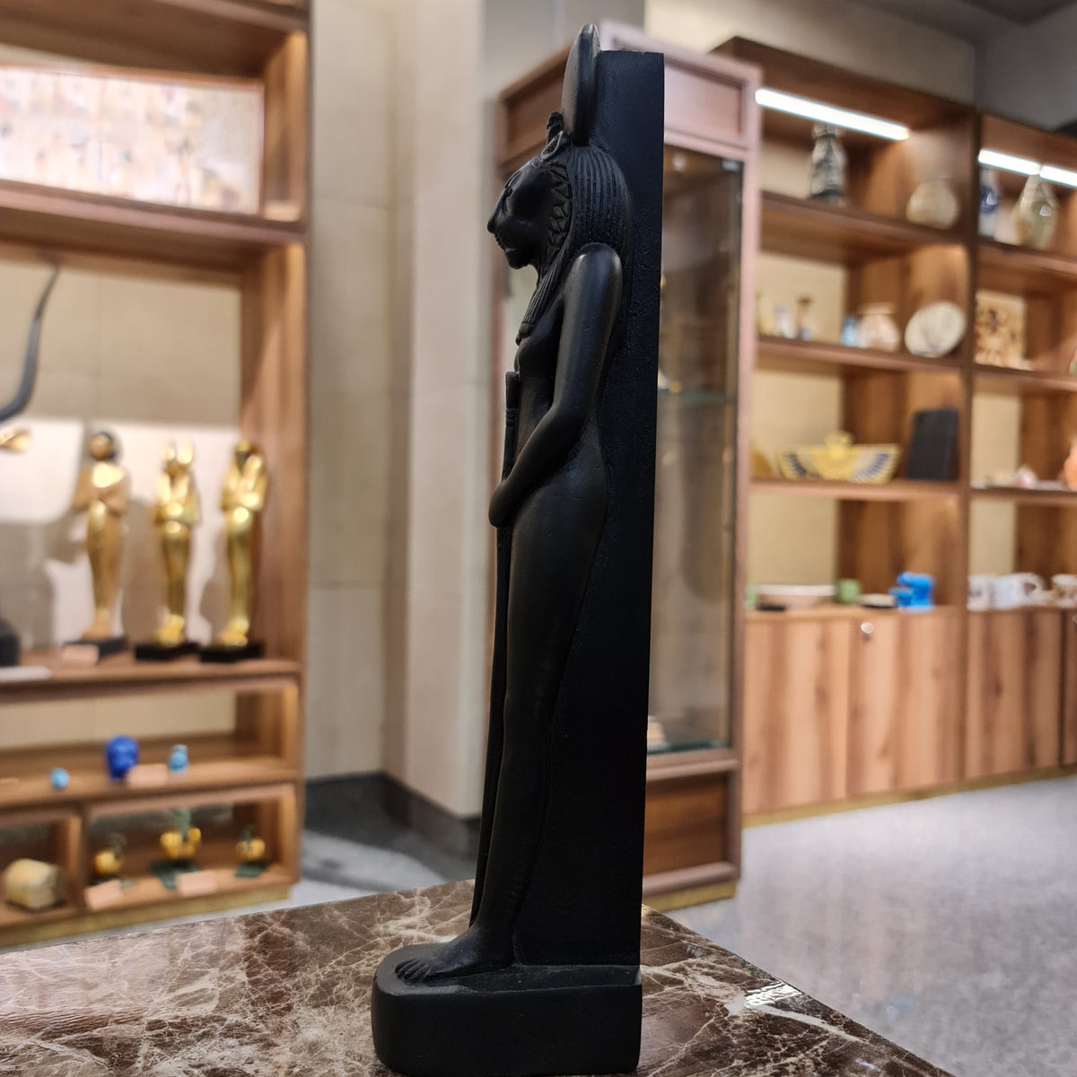 Black Egyptian goddess Sekhmet standing statue museum reproduction, three-quarter view