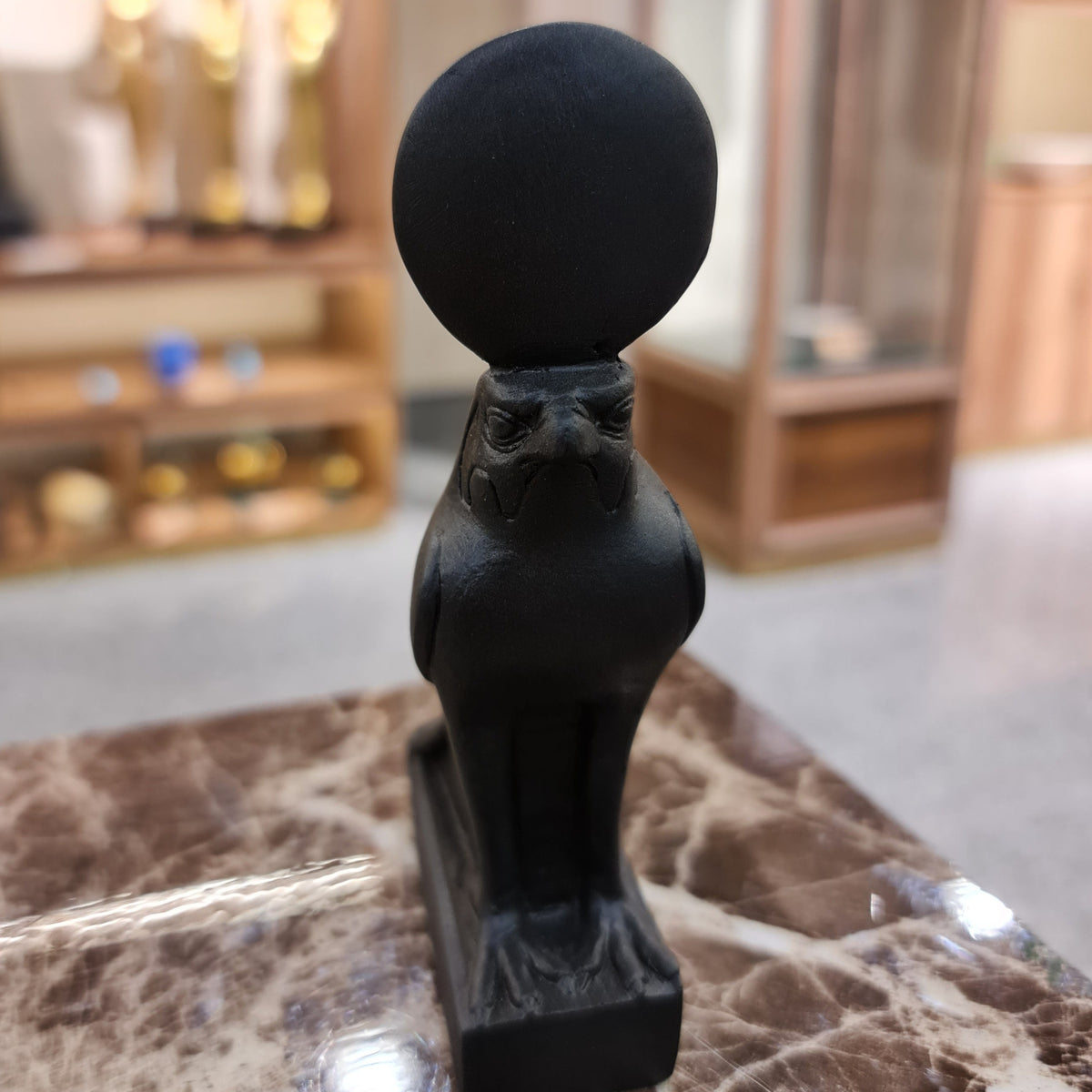 Black Horus falcon statue with sun crown, museum reproduction, front view
