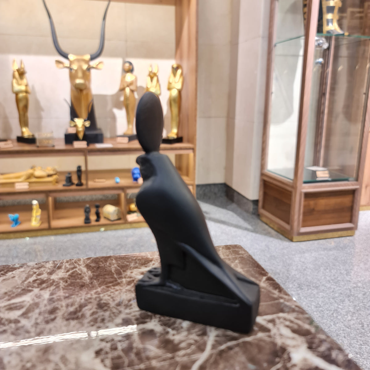 Close-up of the Horus falcon statue's head and crown detail