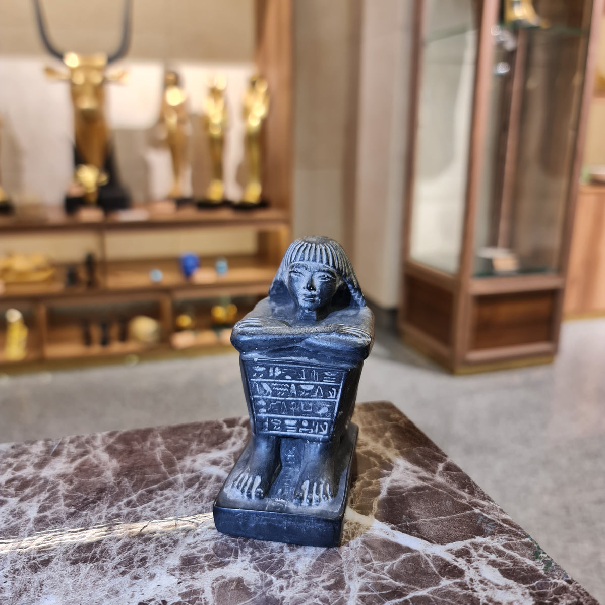 Back view of black cube block statue, colored polyester, museum reproduction