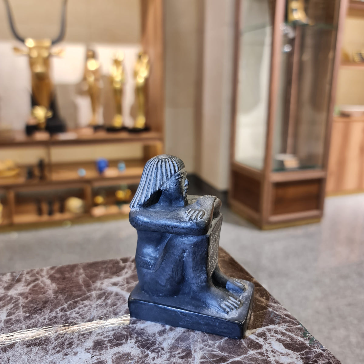 Side profile of black cube block statue, museum reproduction