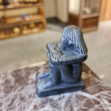 Angled view of black cube block statue, museum reproduction