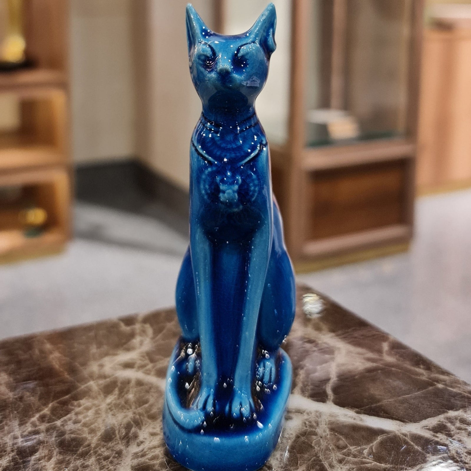 Small Bastet cat goddess statue, stone museum reproduction, front view