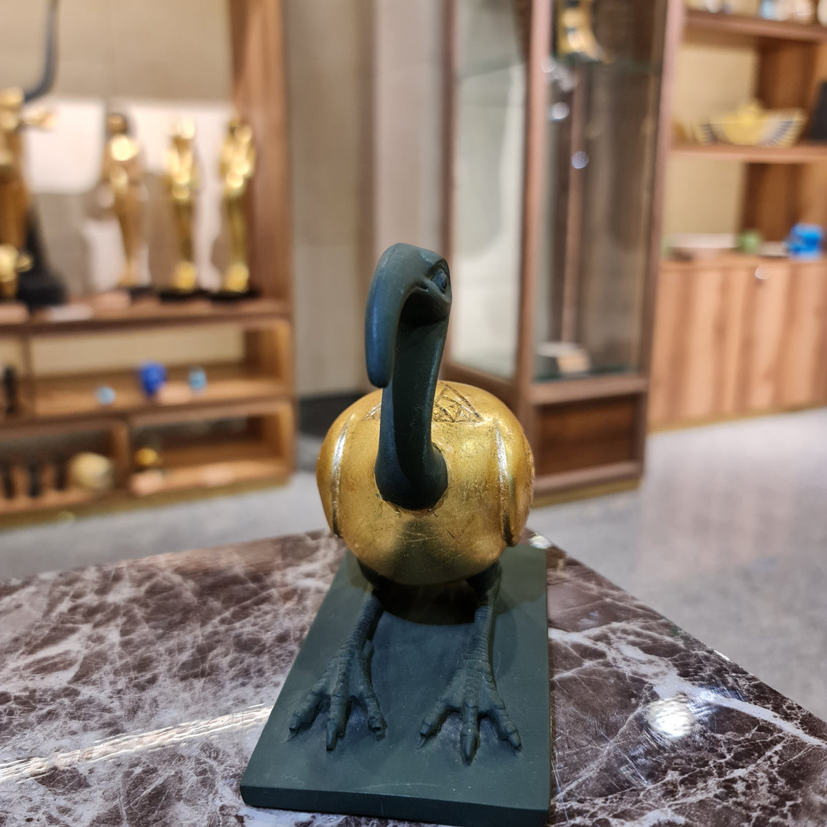Thoth ibis-form statue museum reproduction shown next to a size reference