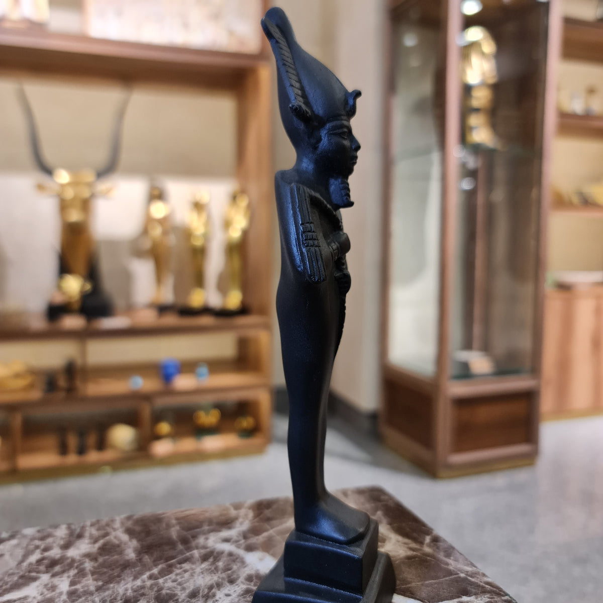 Osiris statue museum reproduction shown holding the crook and flail