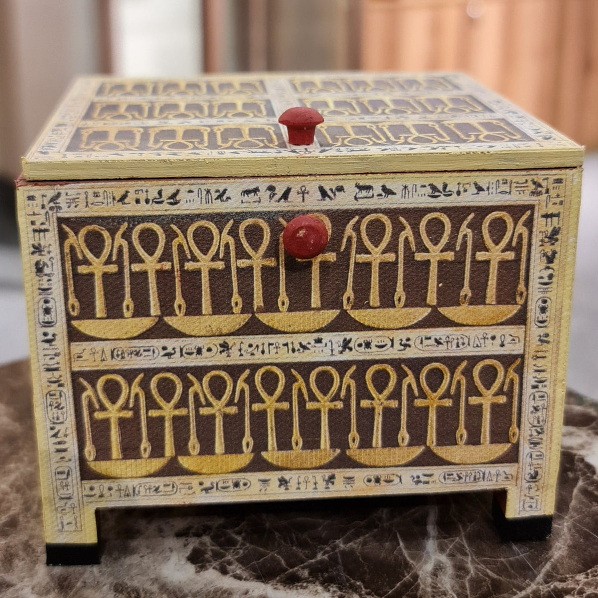 Tutankhamun-motif wooden keepsake box, front view, museum reproduction
