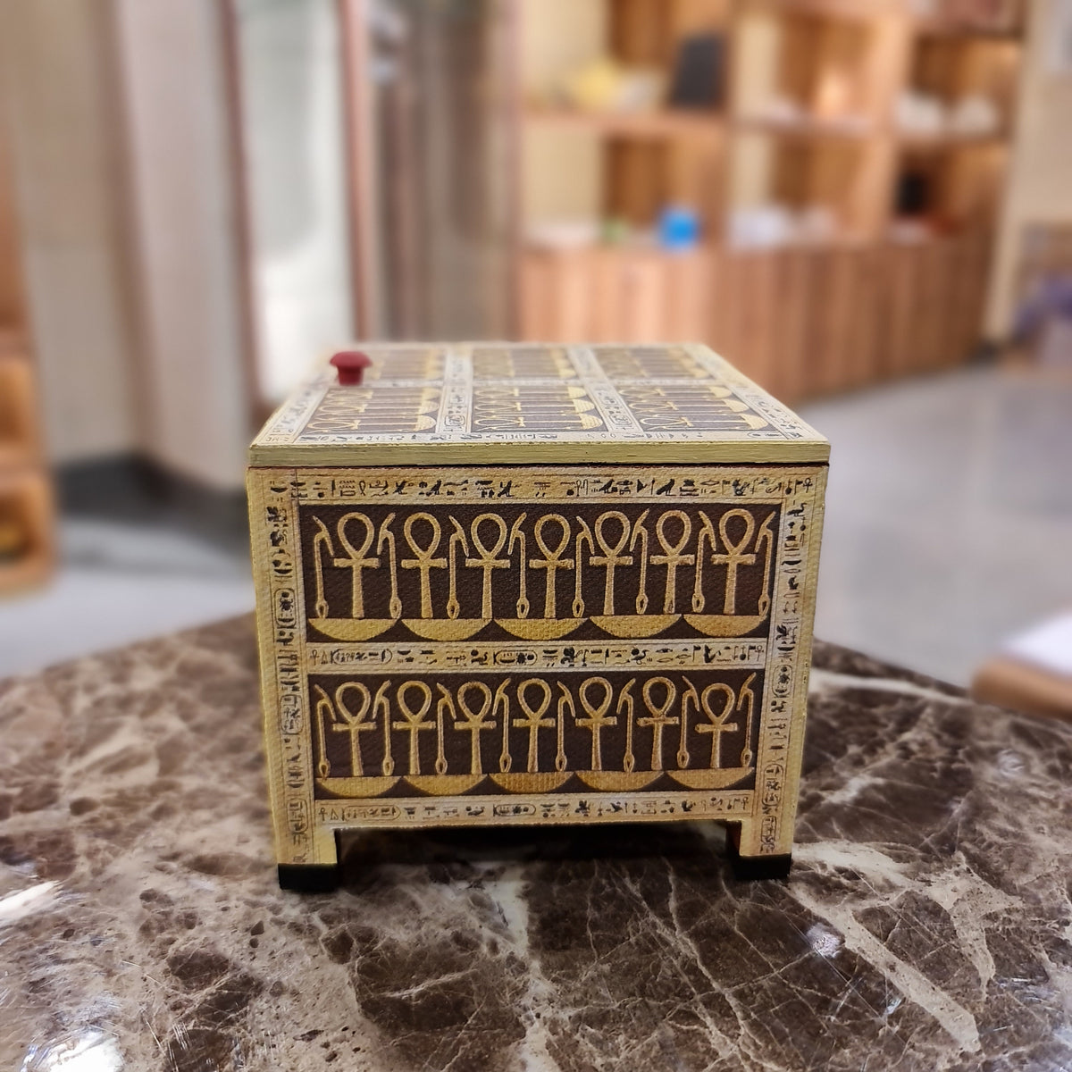 Tutankhamun-motif wooden keepsake box shown for scale