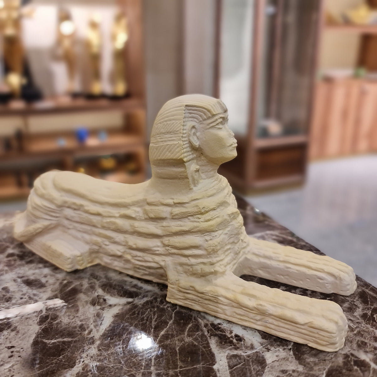 Ancient Egyptian Sphinx statue museum reproduction, side profile
