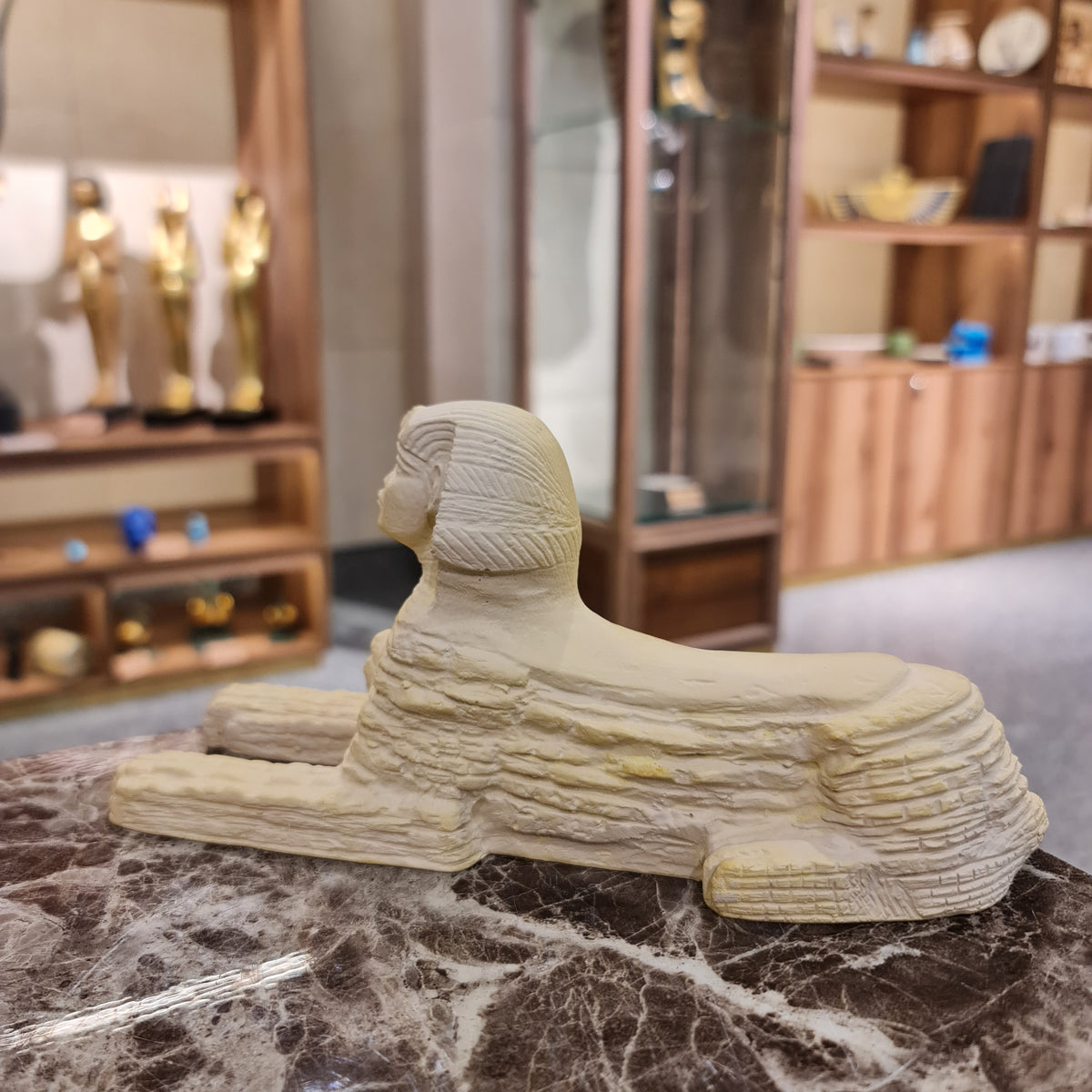 Ancient Egyptian Sphinx statue museum reproduction, three-quarter view