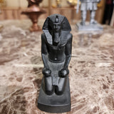 Black kneeling statue of King Thutmose III offering two nu vases, museum reproduction, top angle