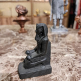 Black kneeling statue of King Thutmose III, museum reproduction, rear view