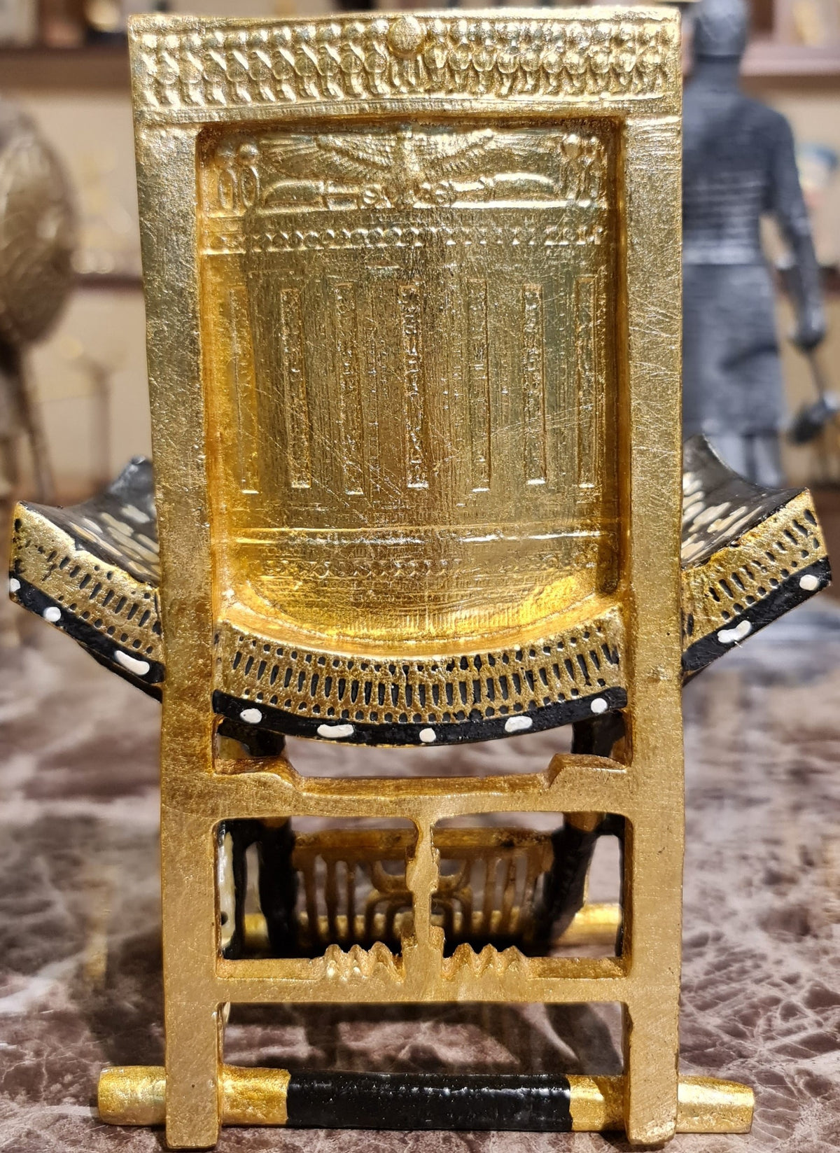 Ceremonial throne of King Tutankhamun museum reproduction displayed on its wooden base