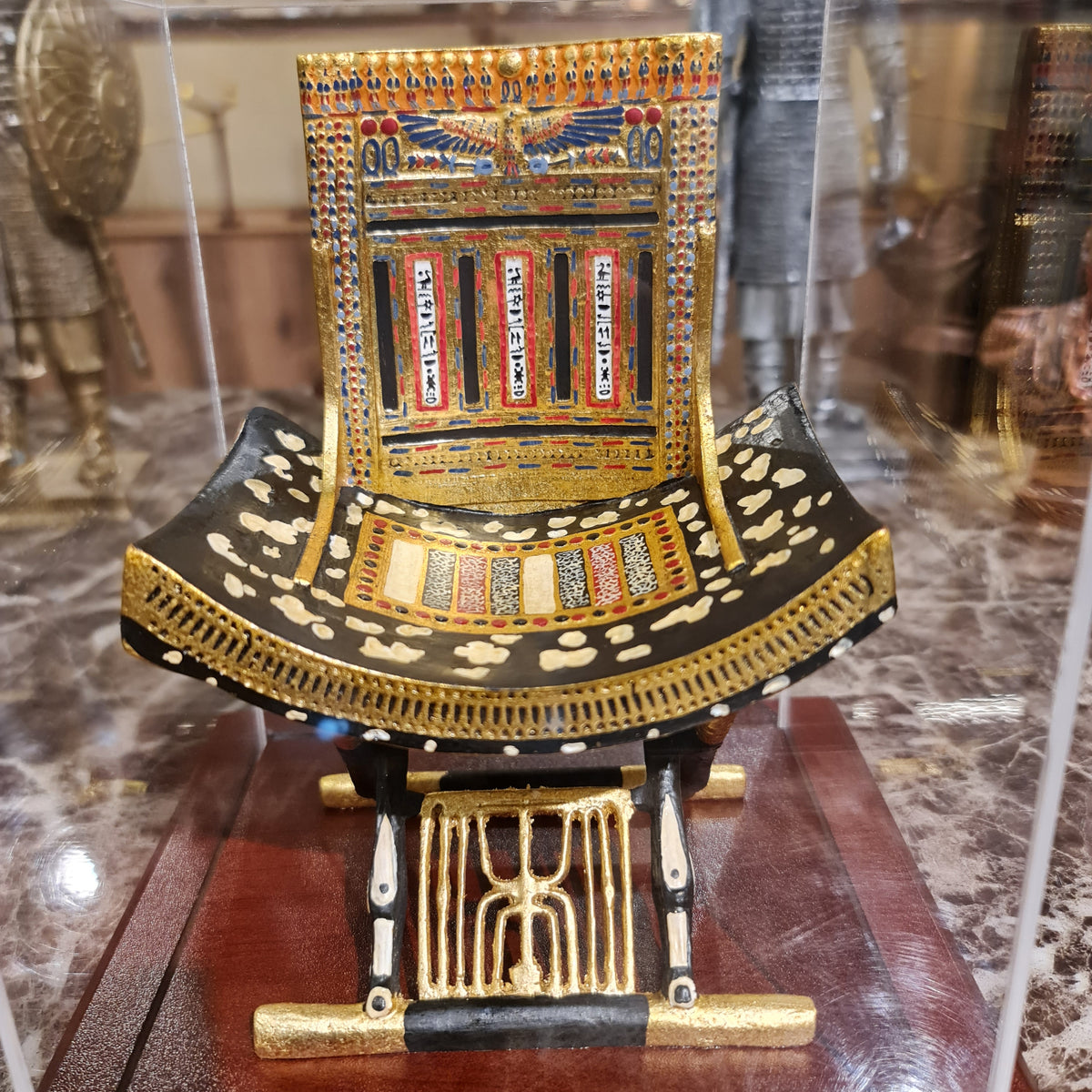 Close-up of the vulture goddess and cartouche detail on the ceremonial throne's backrest
