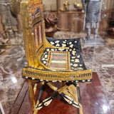 Ceremonial throne of King Tutankhamun museum reproduction in its plexiglass case, side profile