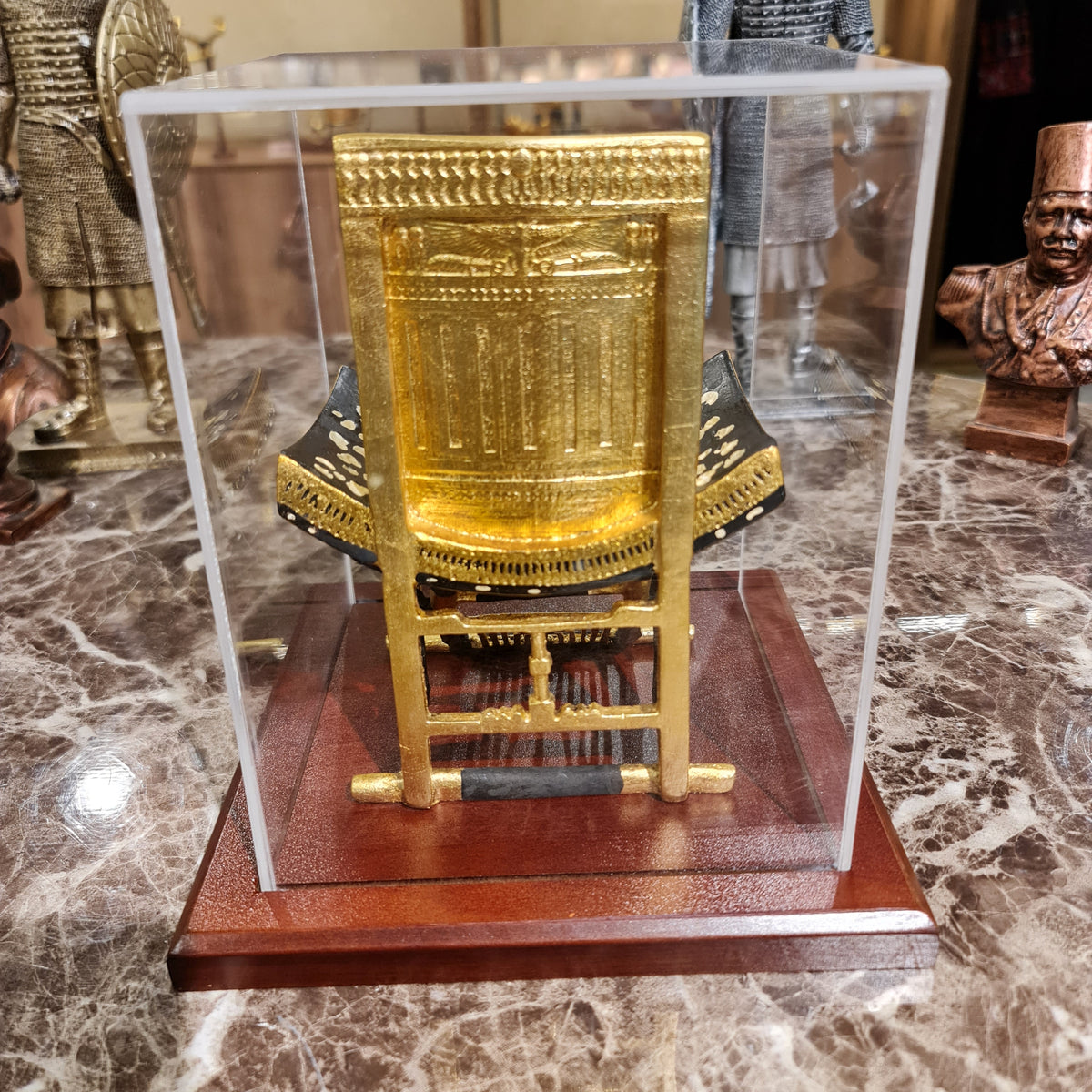 Ceremonial throne of King Tutankhamun museum reproduction on its wooden base