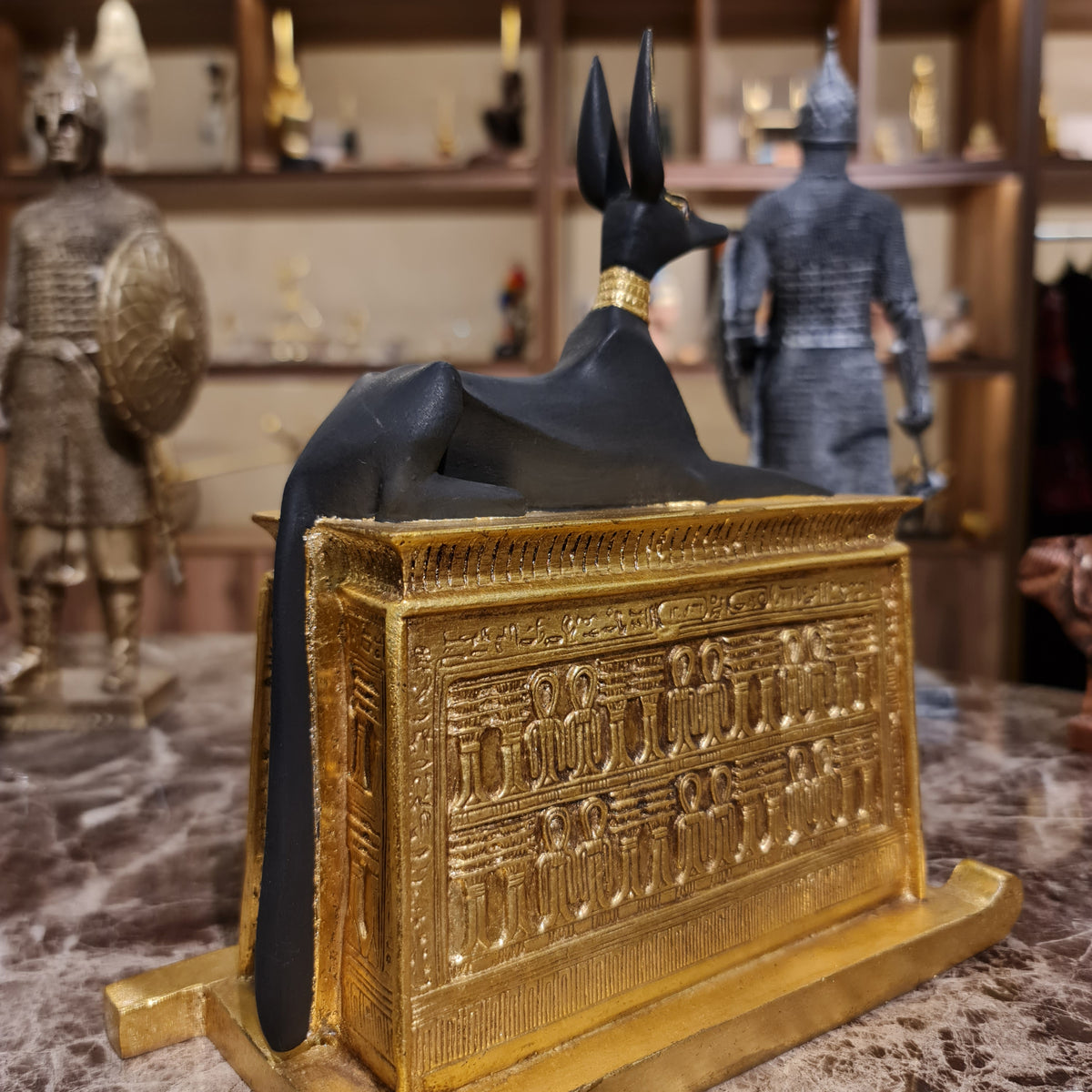 Full-length view of the gilded Anubis shrine statue, museum reproduction
