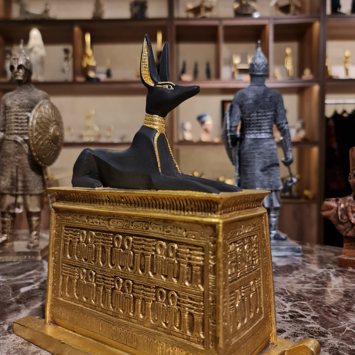 Front view of the gilded Anubis portable shrine statue, museum reproduction