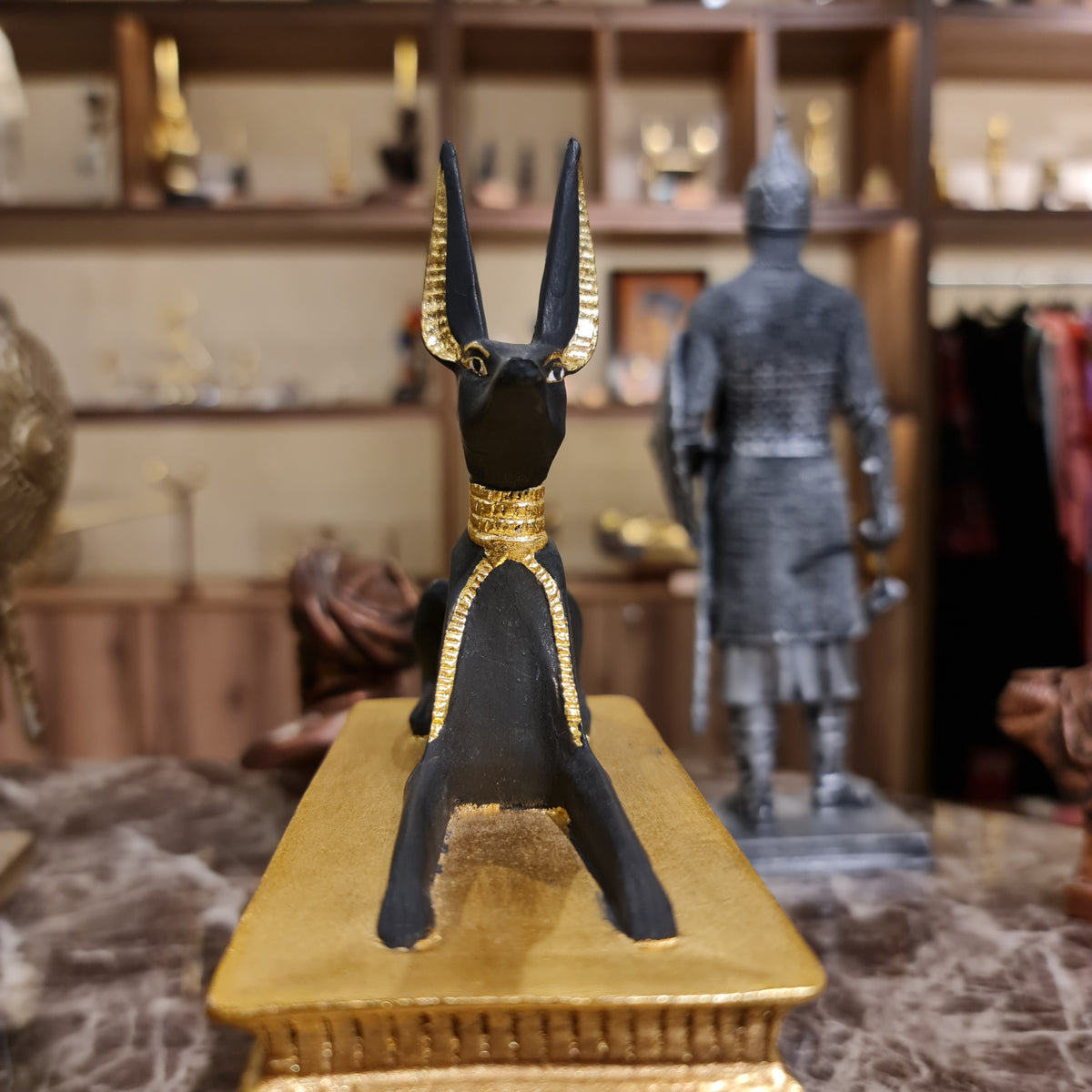 Close-up of the Anubis figure reclining on the ceremonial sled, museum reproduction