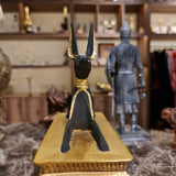 Close-up of the Anubis figure reclining on the ceremonial sled, museum reproduction