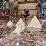 Handmade museum reproduction of Giza's pyramids and Sphinx, close-up on stone texture
