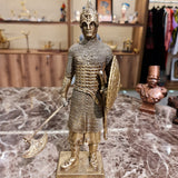 Back view of the golden-finish medieval knight sculpture