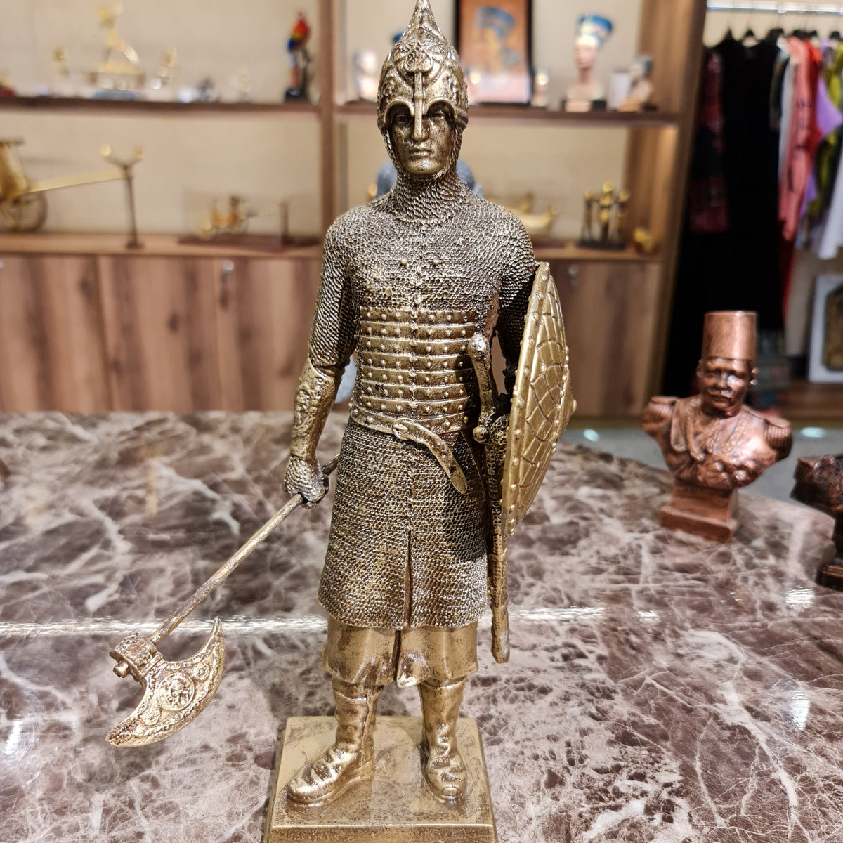 Back view of the golden-finish medieval knight sculpture