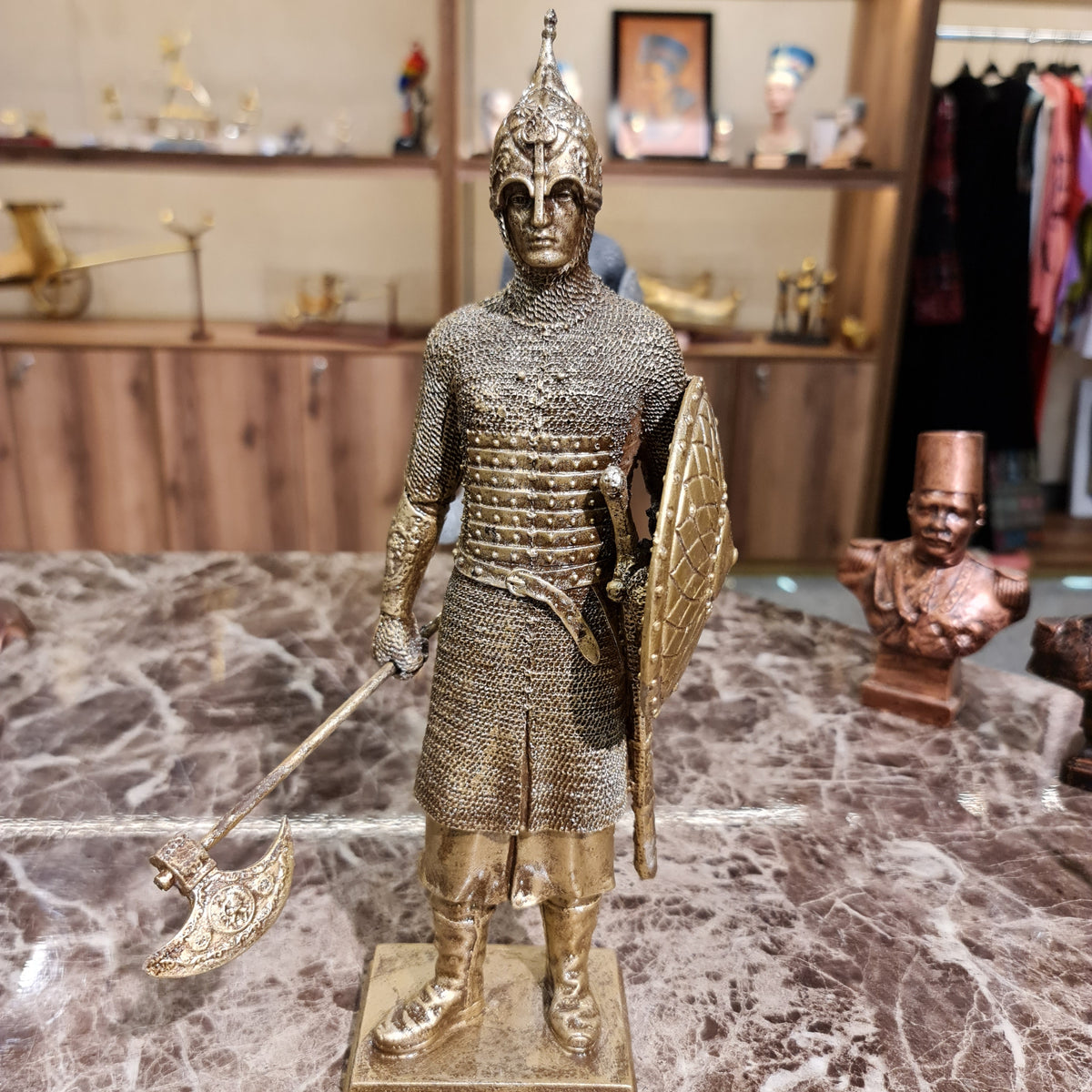 Front view of the golden-finish Armor-Clad Medieval Knight Sculpture with battle axe