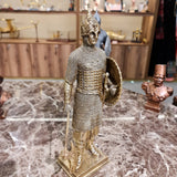 Close-up of the knight sculpture's gilded helmet and armor plating