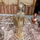 Close-up of the knight sculpture's gilded gauntlet gripping the battle axe