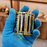 Angled view of gold-plated Shoshenq II bracelet craftsmanship