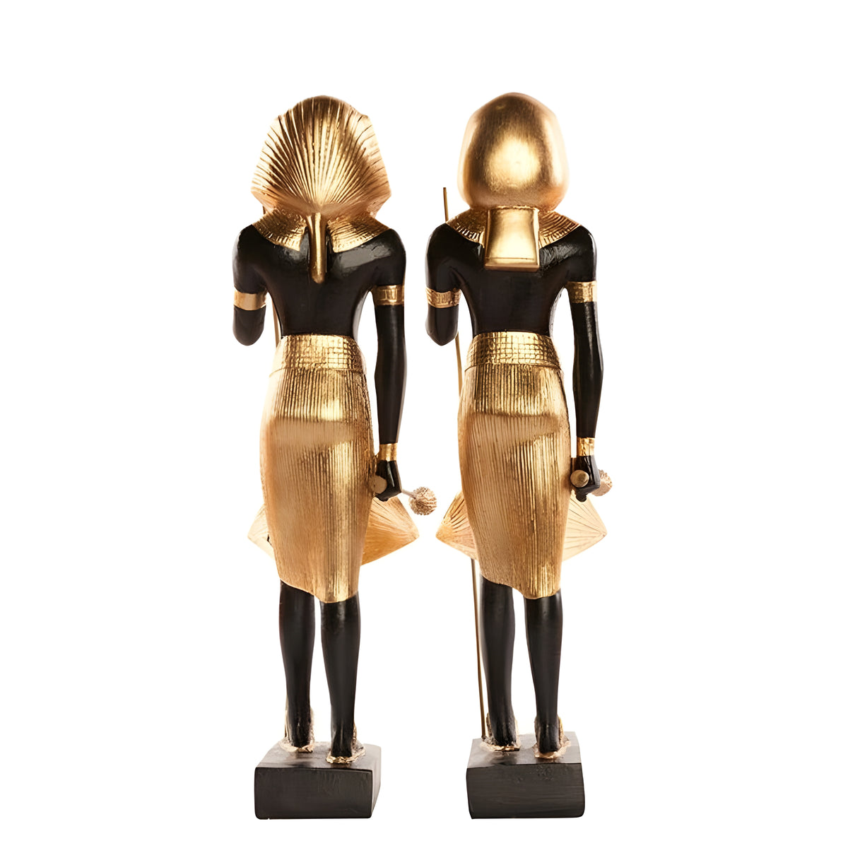 Side view of black and gold guardian statues pair