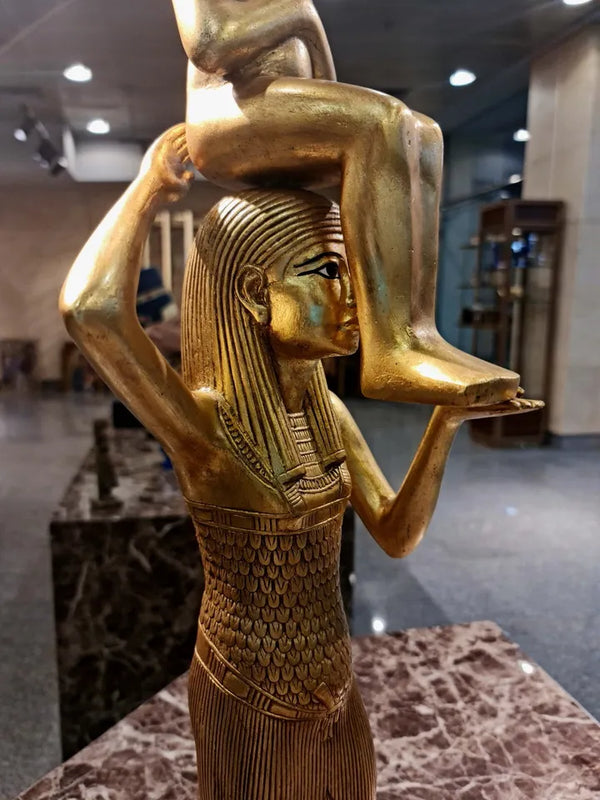 Statue of Goddess Menkeret lifts the mummified King Tutankhamun