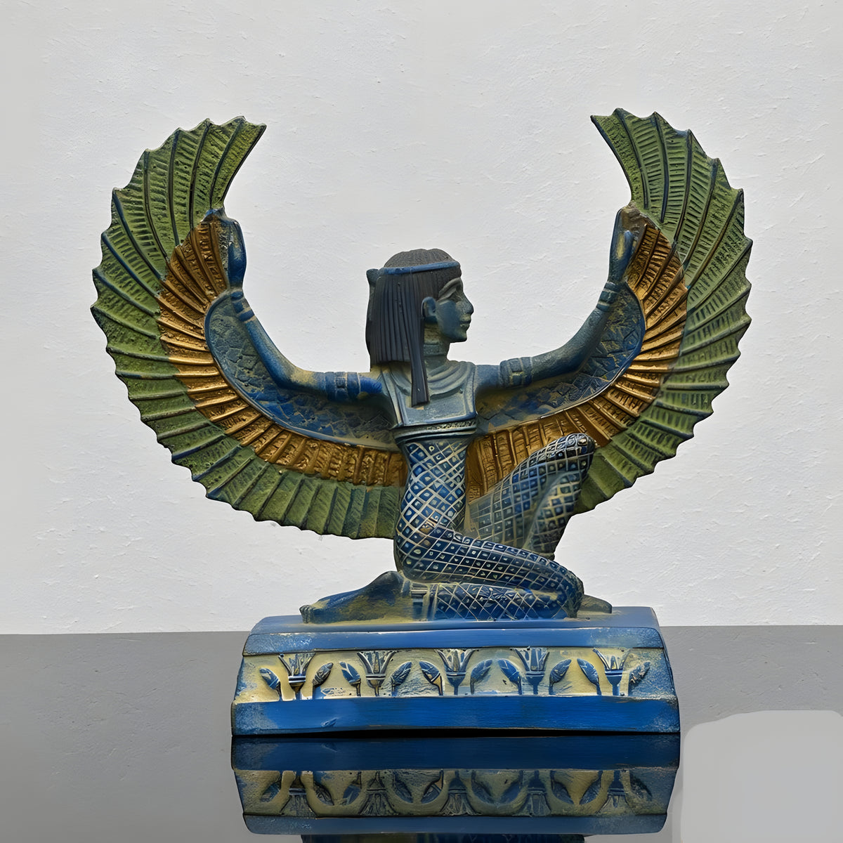 Close-up of wing detail on blue Isis statue