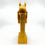 Side view of golden Anubis statue replica