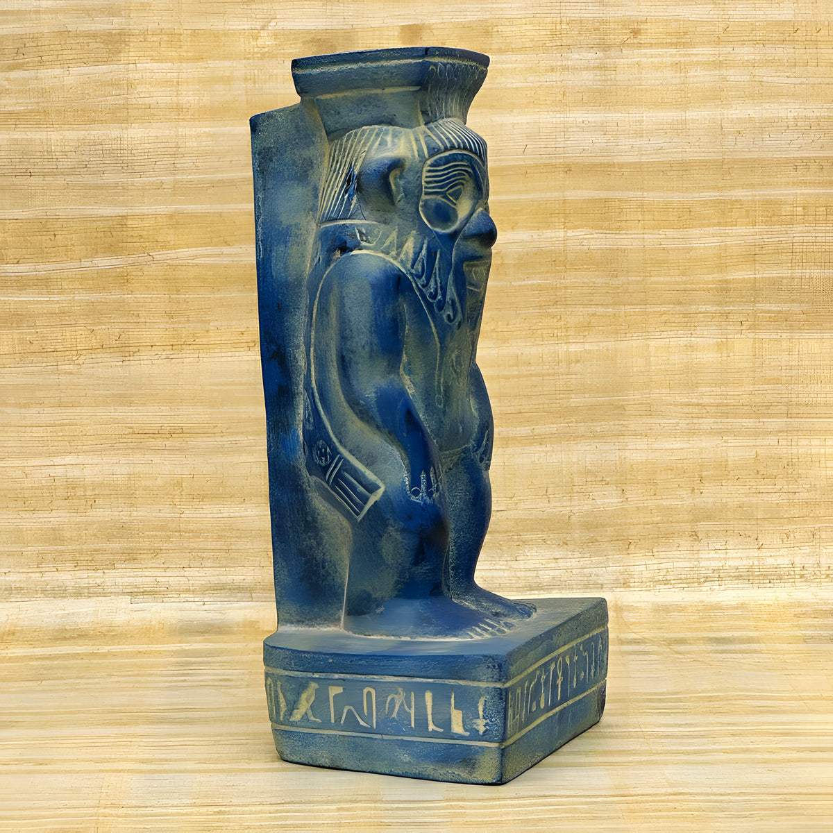 Side view of blue stone Bes statue replica