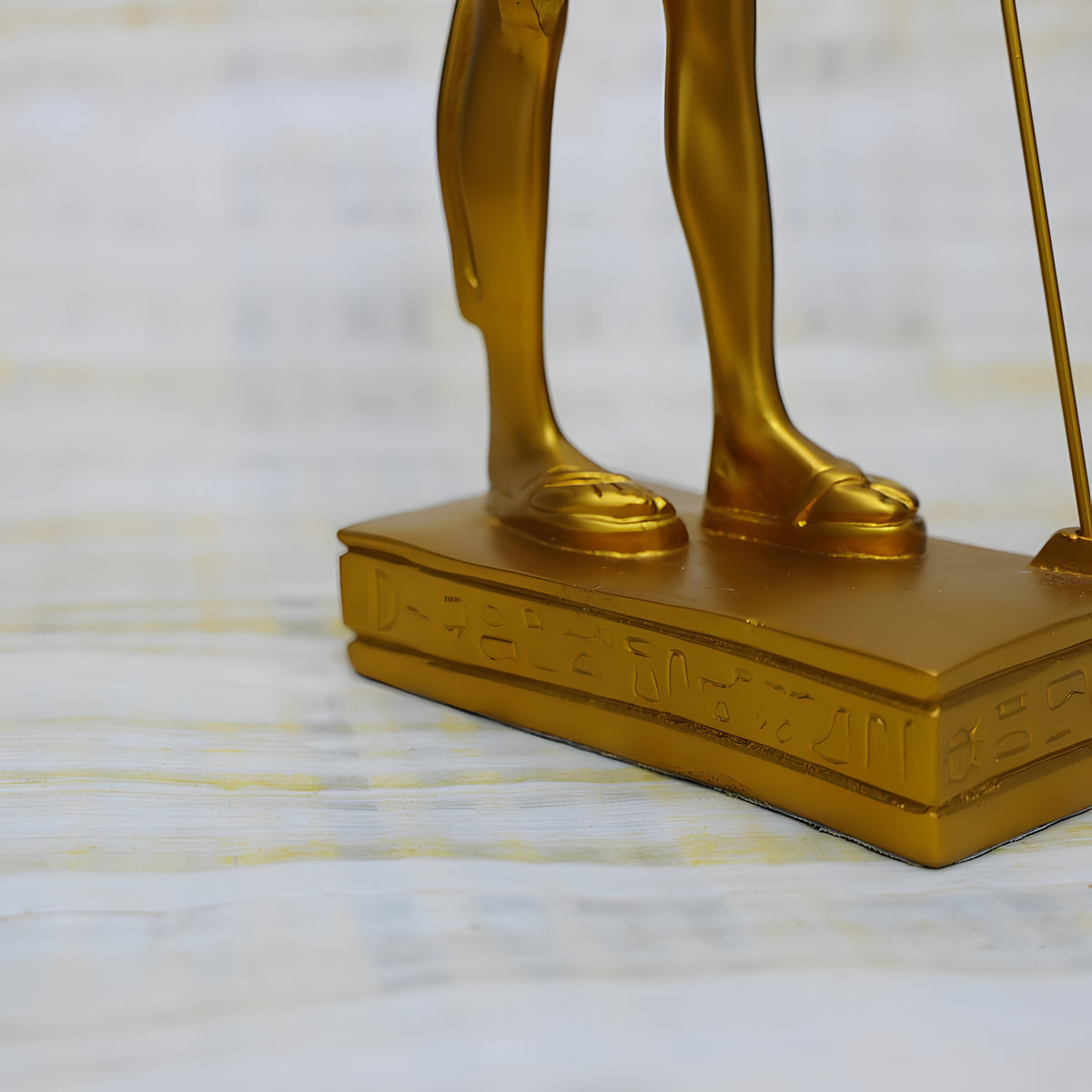 Side view of golden Anubis statue replica