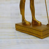 Side view of golden Anubis statue replica