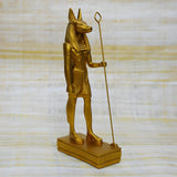 Front view of golden Anubis statue museum reproduction