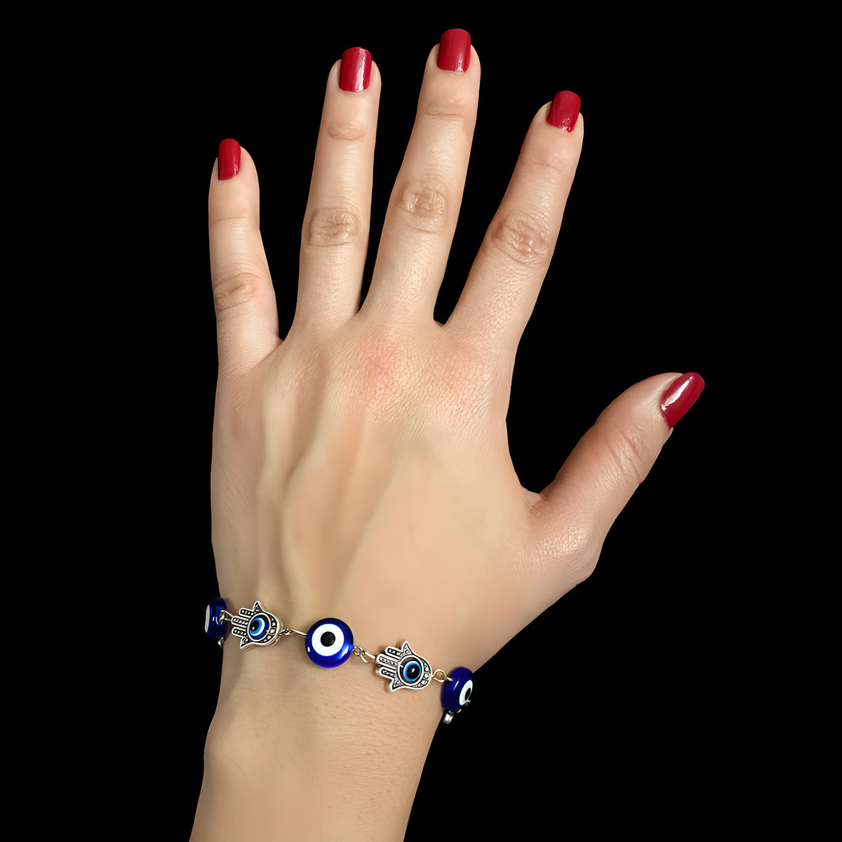 Close-up of the Hamsa and Evil Eye charms on the bracelet