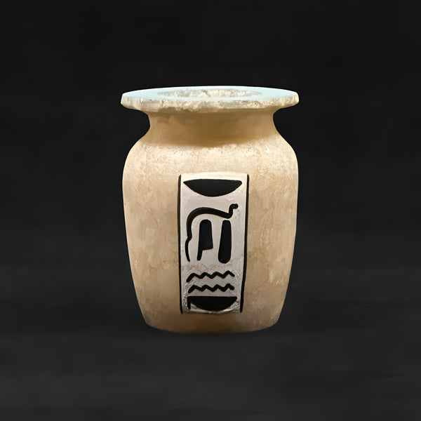 Close-up of winged scarab painting on alabaster vase