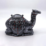 Close-up of gemstone detail on camel coin bank