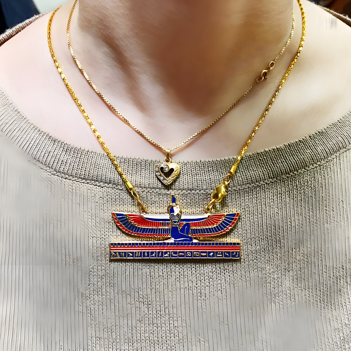 Close-up of the handmade Isis pendant showing carved wing and headdress detail
