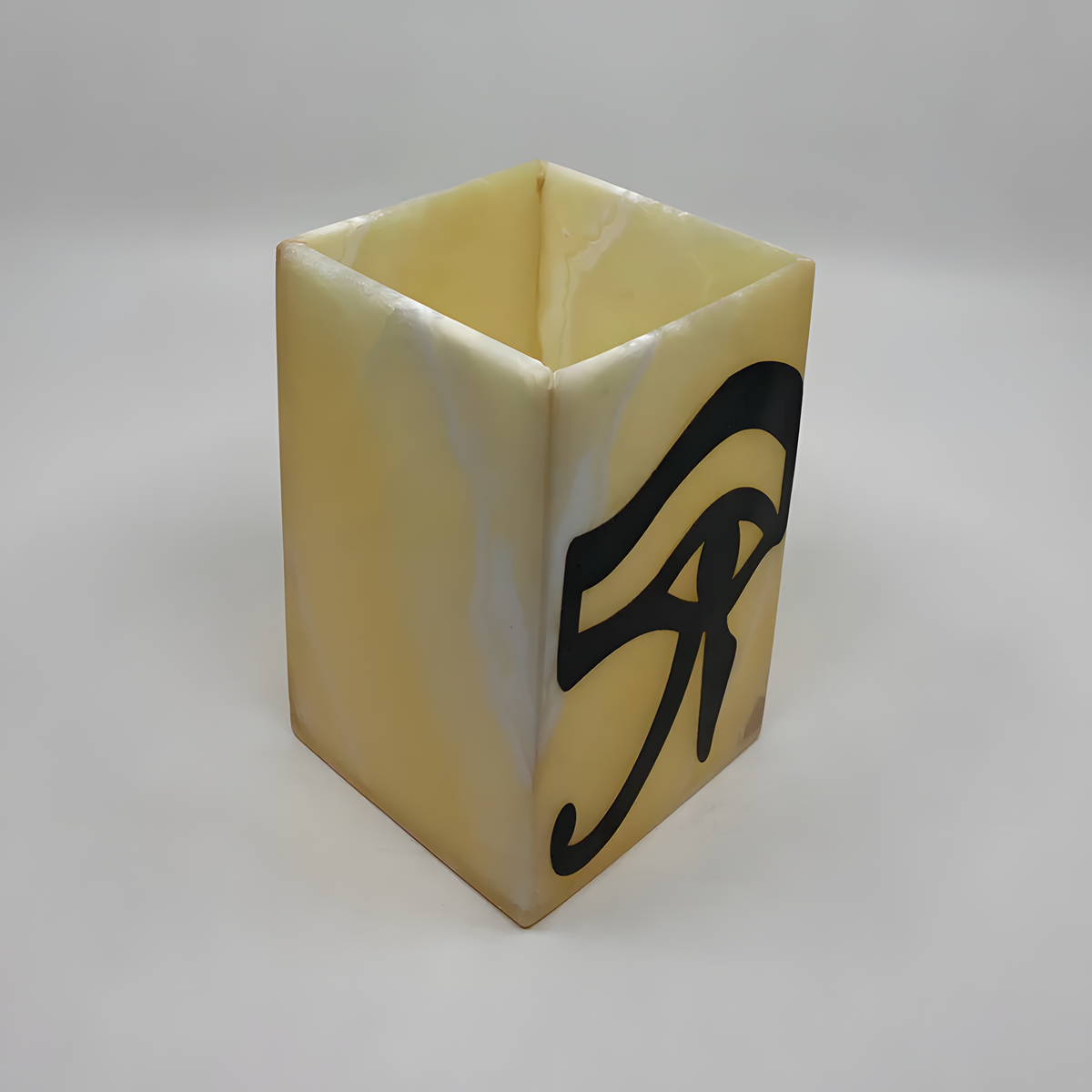 Eye of Horus alabaster vase glowing warmly when lit, museum reproduction
